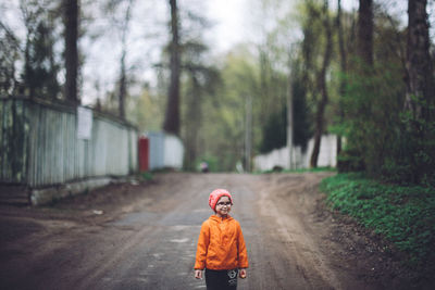 Smiling child standing on road