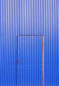 Full frame shot of blue metal on wall