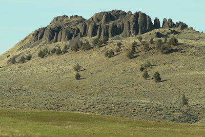 Low angle view of rocky mountain against sky