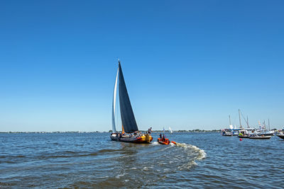 Traditional frisian wooden sailing ship in a yearly competition in the netherlands