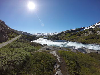 Scenic view of waterfall against sky