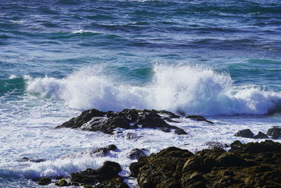 Waves splashing on rocks at shore