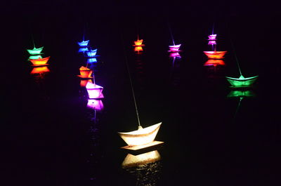 Close-up of illuminated lamp against black background