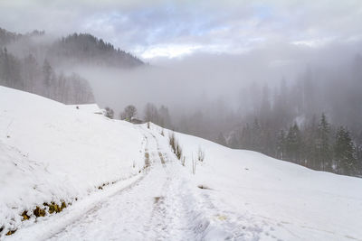 Scenic view of snow covered landscape against sky