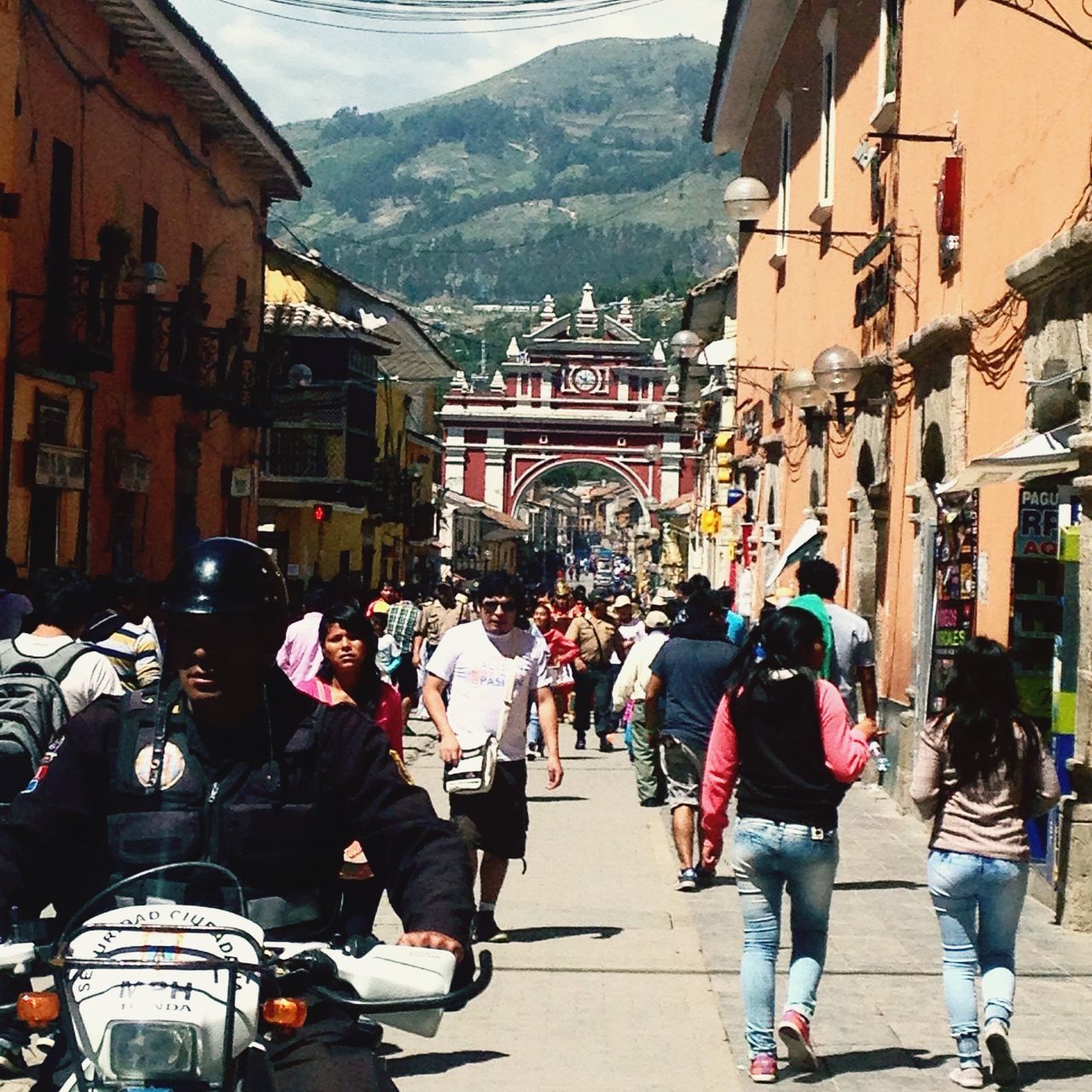 large group of people, men, building exterior, architecture, built structure, person, lifestyles, walking, street, leisure activity, city life, city, mixed age range, transportation, travel, casual clothing, tourist, road, full length