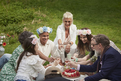 Family having picnic during midsummer