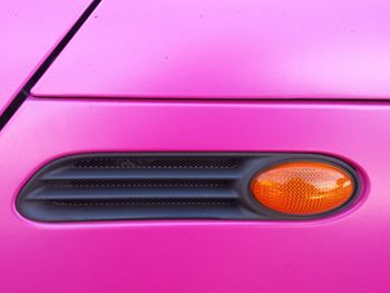 Cropped image of pink car