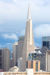 Modern buildings in city against sky