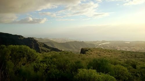 Scenic view of mountains against cloudy sky