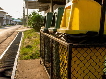 Close-up of yellow train on street in city