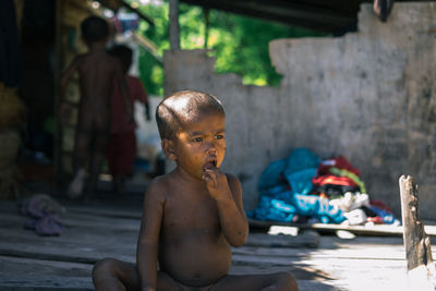 Portrait of shirtless boy looking away