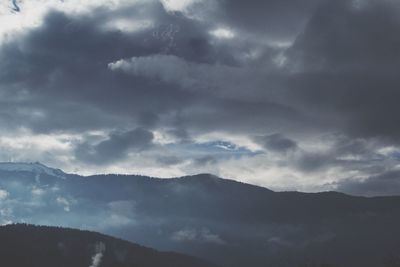 Scenic view of mountains against cloudy sky