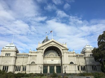 Facade of building against cloudy sky