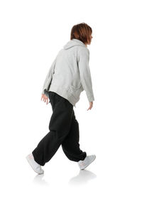 Rear view of woman standing against white background