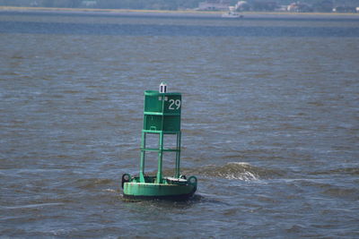 Boat floating on sea against sky