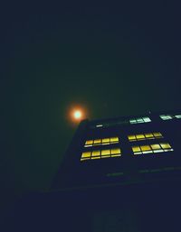 Low angle view of illuminated building against sky