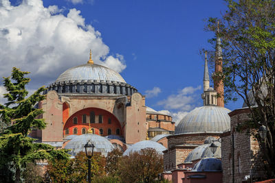 View of mosque in city against sky