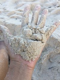 Close-up of hand holding sand