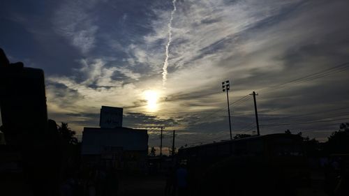 Silhouette city against sky during sunset