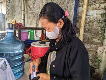 Woman wearing mask working outdoors