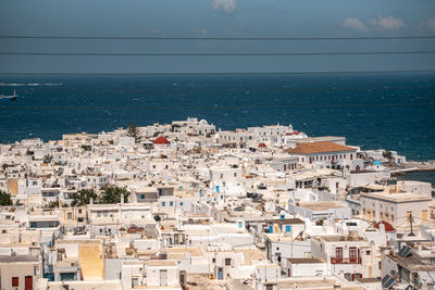 High angle view of townscape by sea against sky