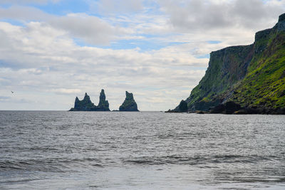 Scenic view of sea against sky. famous rock formation iceland