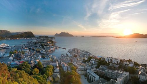 High angle view of townscape by sea against sky