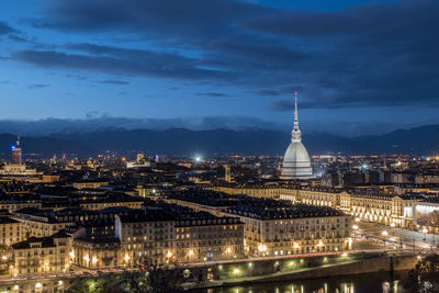 High angle view of city lit up at night