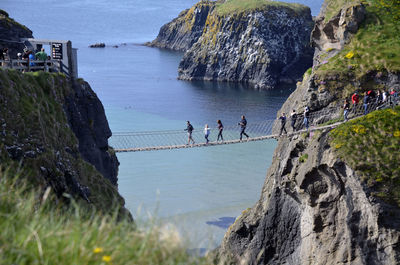 People walking on carrick-a-rede rope bridge