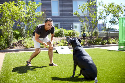 A man playing with his dog.