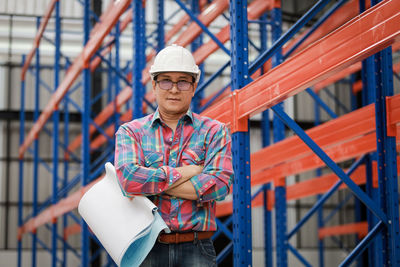 Portrait of man working on railing