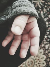 Close-up of hand holding baby