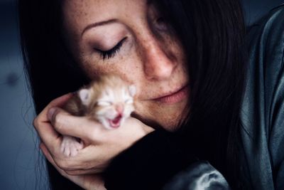 Close-up of woman holding kitten