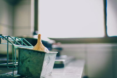 Close-up of clothespins on table against window