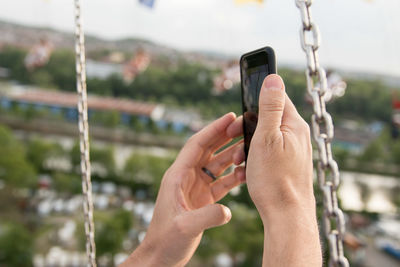 Midsection of man using mobile phone