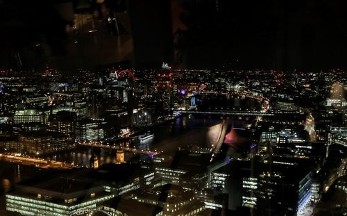 High angle view of illuminated buildings in city at night