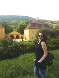 Full length of woman standing on grass against sky