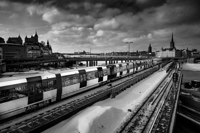 Train at railroad station platform against sky