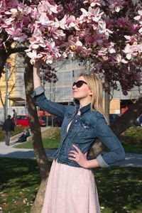 Woman wearing sunglasses standing in park