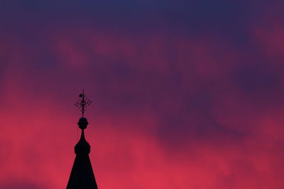 Low angle view of silhouette building against sky at sunset