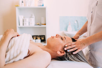 Cosmetologist does facial massage for woman. beauty skin care