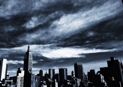 City skyline against cloudy sky