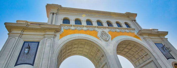 Low angle view of historical building against blue sky