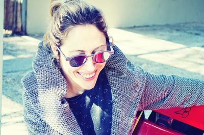 Portrait of smiling young woman wearing sunglasses