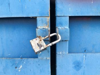 Close-up of padlock on blue door