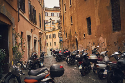 Bicycles parked on street amidst buildings in city