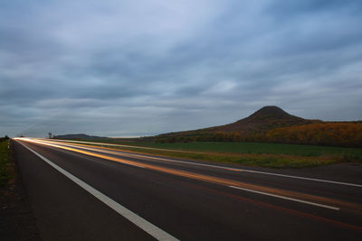 Empty road along countryside landscape