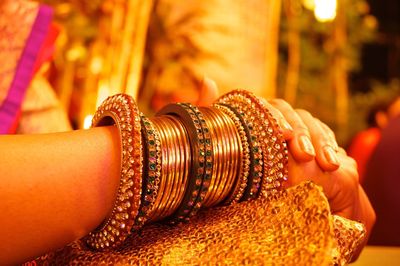 Close-up of old colored bangles in human hand