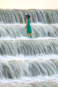 Full length of woman standing in pond