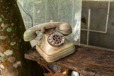 Close-up of old telephone on table